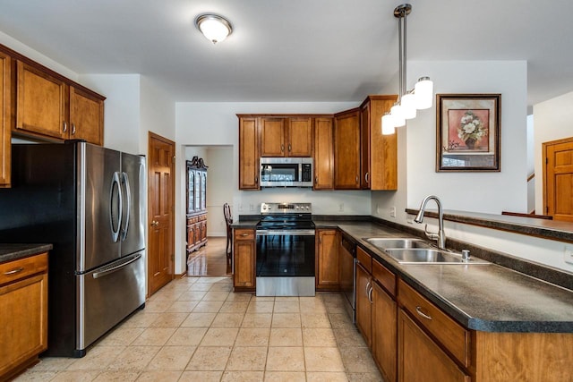 kitchen featuring stainless steel appliances, hanging light fixtures, sink, and light tile patterned floors