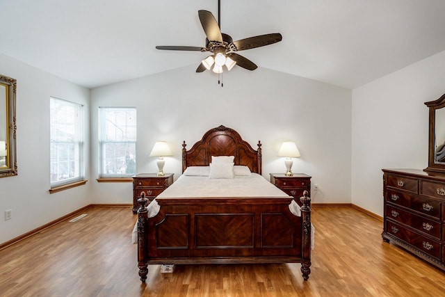 bedroom featuring ceiling fan, vaulted ceiling, and light wood-type flooring