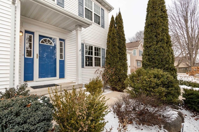 view of snow covered property entrance