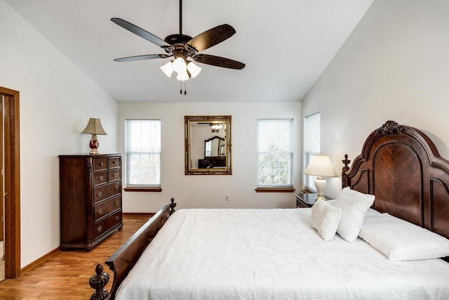 bedroom featuring ceiling fan, lofted ceiling, and light wood-type flooring