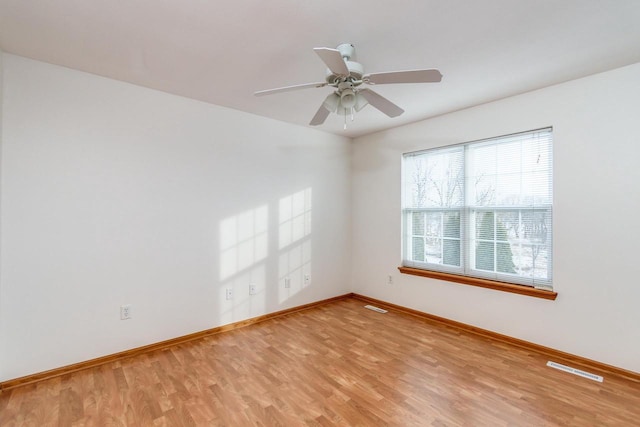 empty room featuring ceiling fan and light wood-type flooring