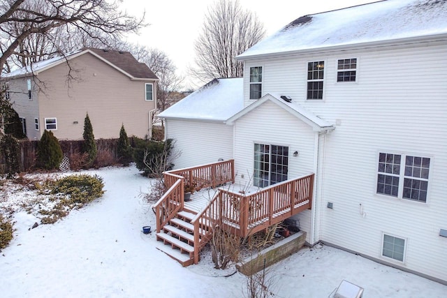 snow covered property featuring a wooden deck