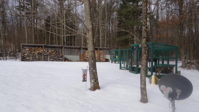 yard covered in snow with a playground