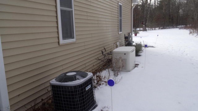 view of snowy exterior featuring cooling unit