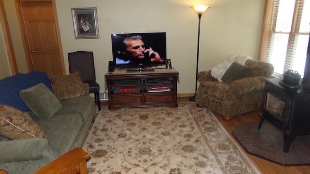 living room featuring a wood stove and hardwood / wood-style floors