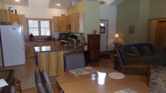 kitchen featuring sink, high vaulted ceiling, and white fridge