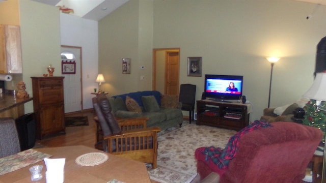 living room with high vaulted ceiling