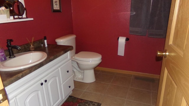 bathroom featuring vanity, toilet, and tile patterned floors