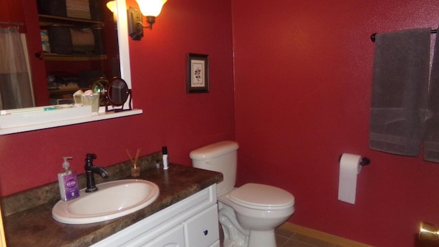 bathroom featuring vanity, toilet, and tile patterned flooring