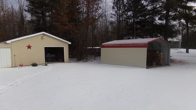 snow covered garage featuring a carport