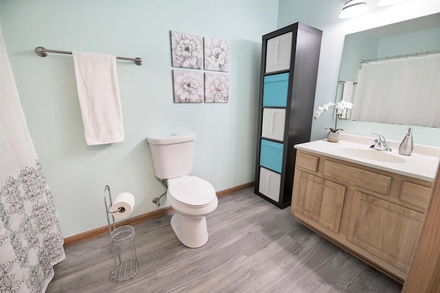 bathroom featuring hardwood / wood-style flooring, vanity, and toilet