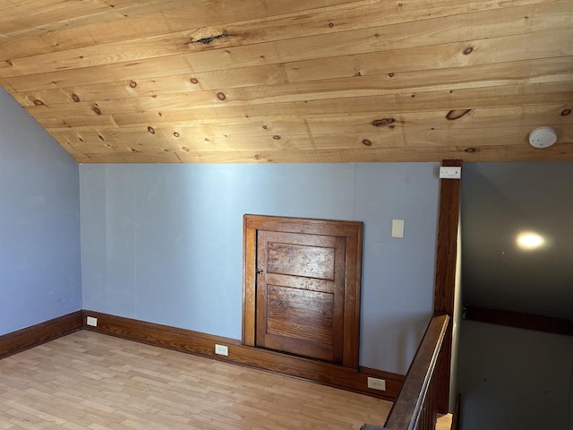 additional living space featuring light hardwood / wood-style floors, lofted ceiling, and wood ceiling