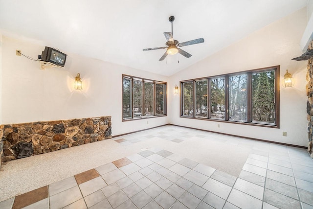 interior space featuring ceiling fan, light colored carpet, and lofted ceiling