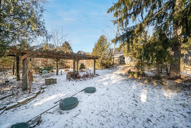 snowy yard featuring a pergola