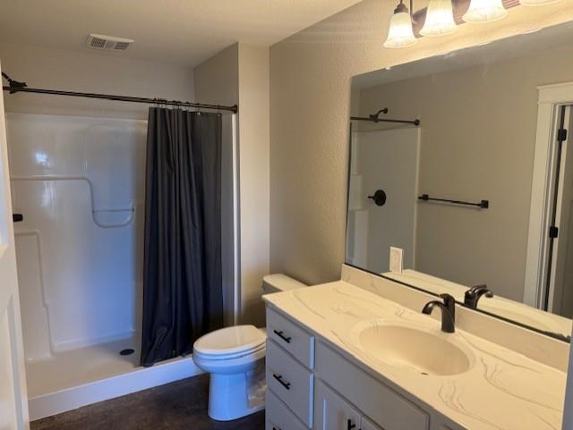 bathroom featuring a shower with curtain, toilet, and vanity