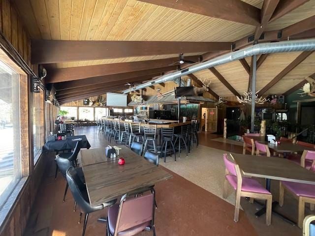 dining area with vaulted ceiling with beams and wood ceiling