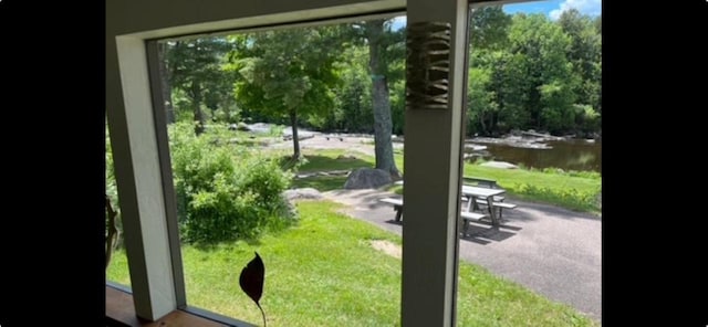 doorway to outside with a water view