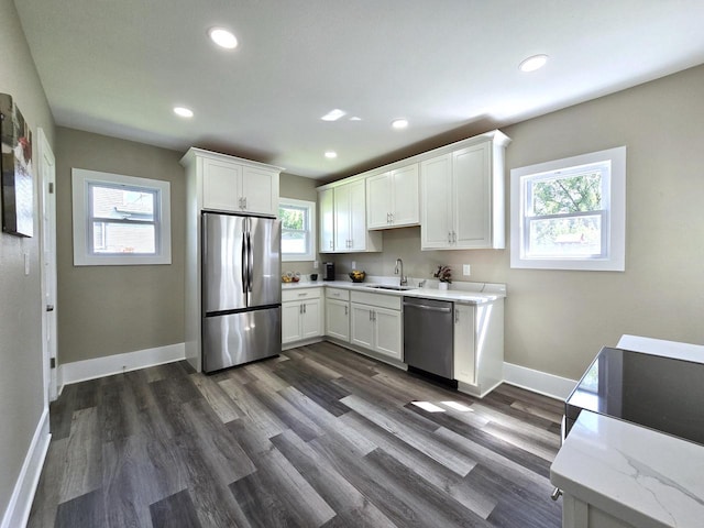 kitchen featuring white cabinets, a wealth of natural light, appliances with stainless steel finishes, and sink