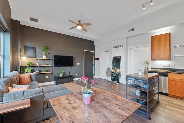 living room featuring ceiling fan and light hardwood / wood-style flooring