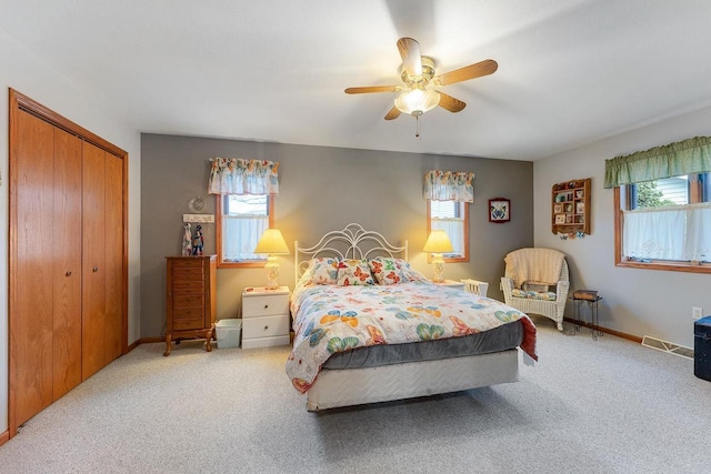 bedroom with a closet, ceiling fan, and carpet floors