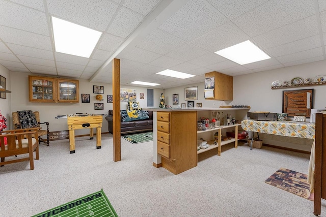 bedroom featuring a paneled ceiling and light carpet