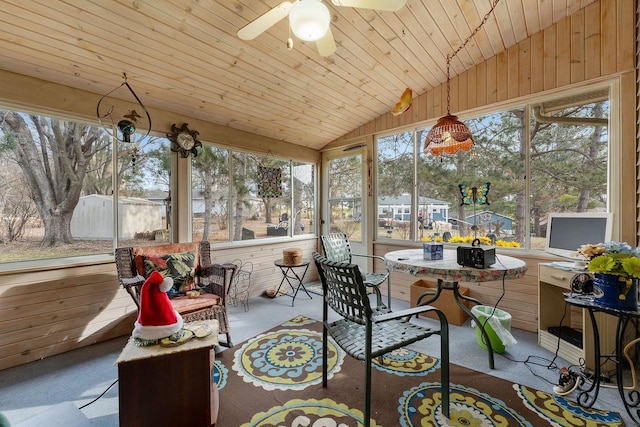 sunroom with wooden ceiling, plenty of natural light, ceiling fan, and vaulted ceiling