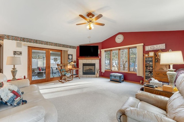 living room with carpet flooring, a fireplace, french doors, ceiling fan, and lofted ceiling