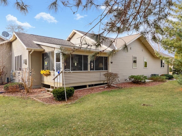 view of property exterior featuring a sunroom and a yard