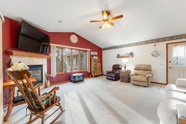 living room featuring light carpet, a tile fireplace, a healthy amount of sunlight, and ceiling fan