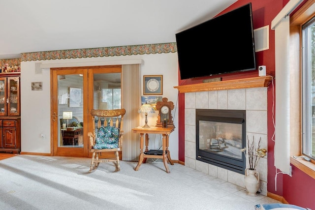 sitting room with light carpet and a fireplace