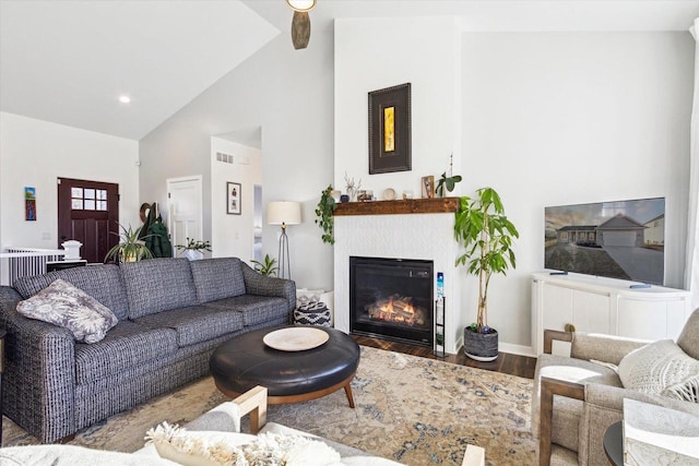 living room with wood-type flooring, high vaulted ceiling, and beamed ceiling