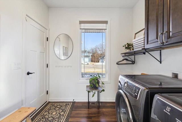 washroom featuring separate washer and dryer, dark hardwood / wood-style floors, and cabinets