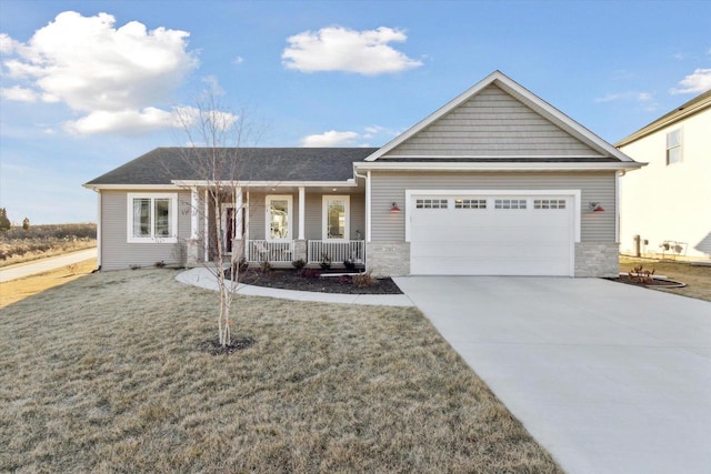 ranch-style home featuring a garage, covered porch, and a front yard