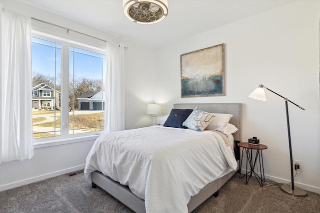 carpeted bedroom featuring multiple windows