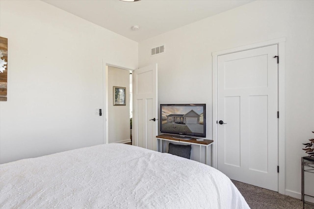 bedroom featuring dark carpet