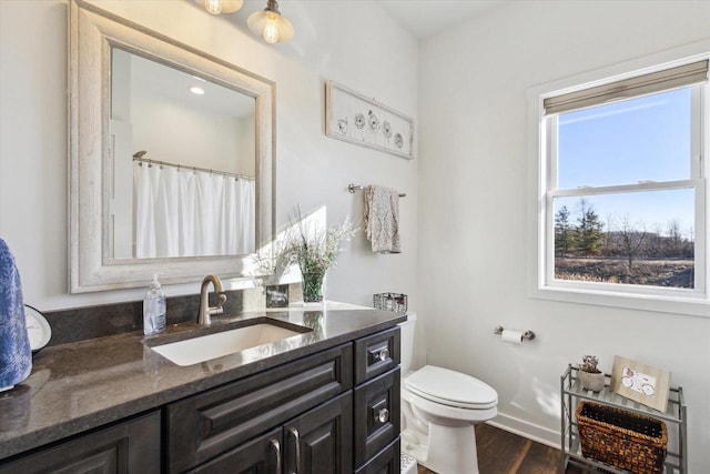 bathroom featuring hardwood / wood-style flooring, vanity, and toilet