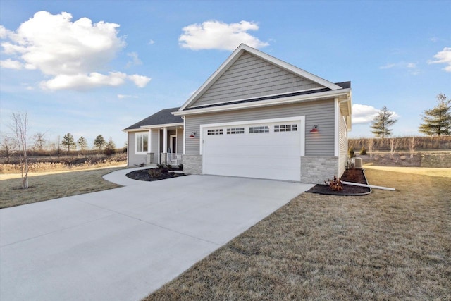 view of front facade featuring a garage, covered porch, and a front lawn