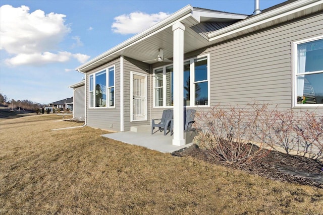 back of property with a patio and a lawn