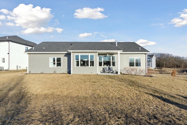 rear view of property featuring a patio area and a lawn