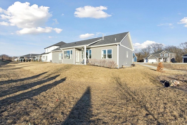 back of house featuring a lawn