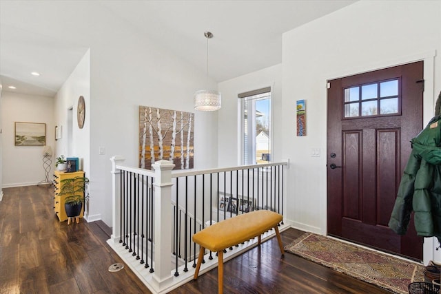 entrance foyer featuring plenty of natural light and dark hardwood / wood-style floors