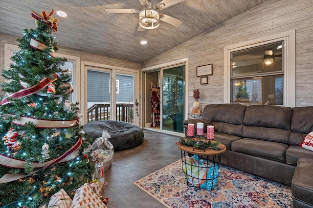 living room with ceiling fan, wood walls, vaulted ceiling, and wooden ceiling