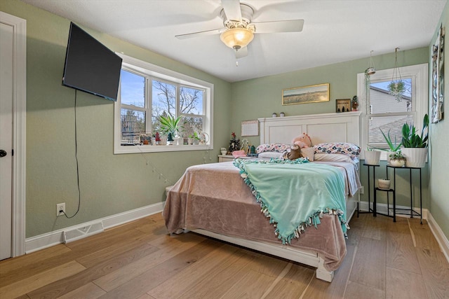 bedroom with wood-type flooring and ceiling fan