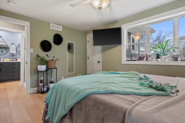 bedroom featuring ceiling fan, lofted ceiling, and light hardwood / wood-style flooring