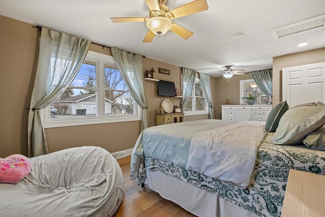 bedroom featuring light hardwood / wood-style floors and ceiling fan