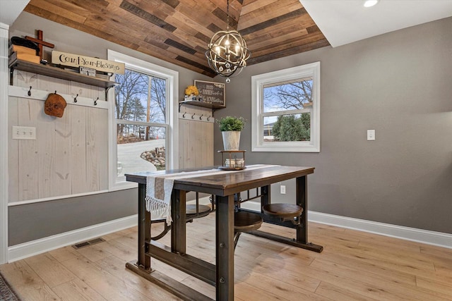 dining space with an inviting chandelier, vaulted ceiling, wooden ceiling, and light wood-type flooring