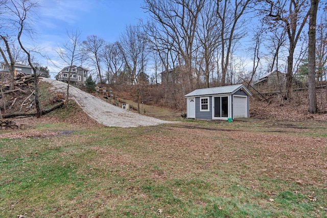 view of yard with a garage and an outdoor structure