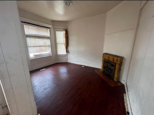 unfurnished living room with dark hardwood / wood-style flooring