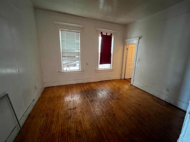 spare room with wood-type flooring