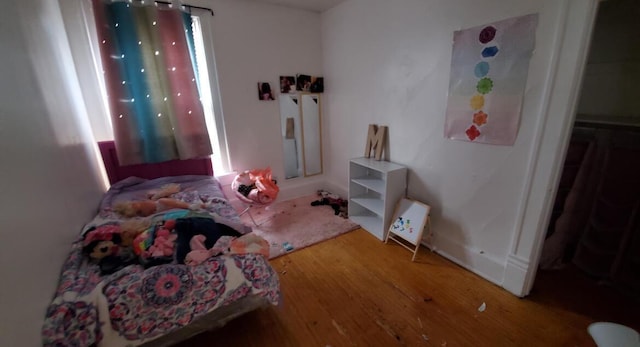 bedroom with hardwood / wood-style flooring